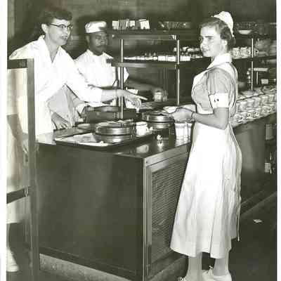 Student nurse and dietician in cafeteria