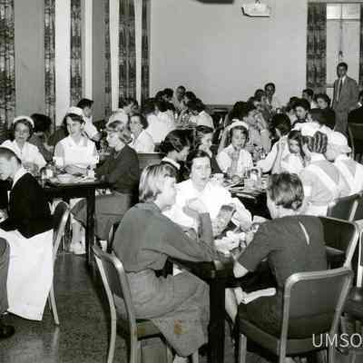 Students, nurse, and physicians at cafeteria tables