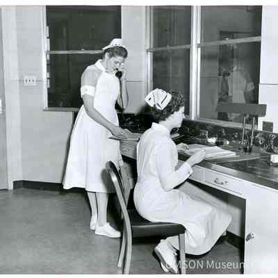 Nursing student and nurse at nurses station