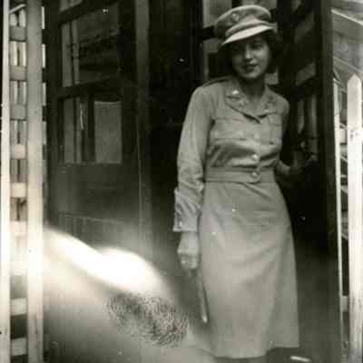 Doris Alt (Anna Doris Alt, DIN 1942) at door of a phone booth, Australia