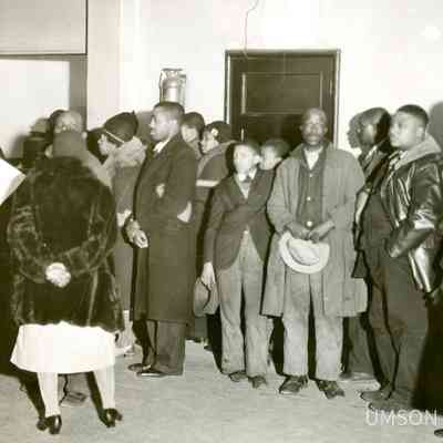 Black patients standing in line, basement of University Hospital, Lombard and Green Streets, 1934