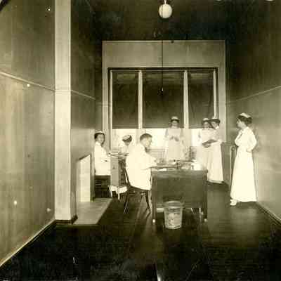 Upper Hall, University Hospital, 1912 with nurses, nursing students, and male employee