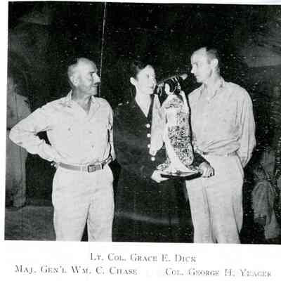 Halftone image of Lieutenant Colonel Grace E. Dick, Major General William C. Chase, and Colonel George H. Yeager with Japanese doll, 1945