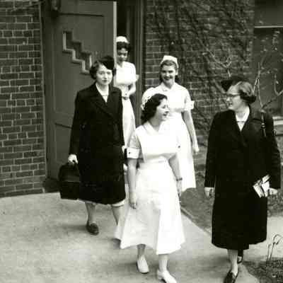 Students leaving Parsons Hall in uniforms for class and public health rotations