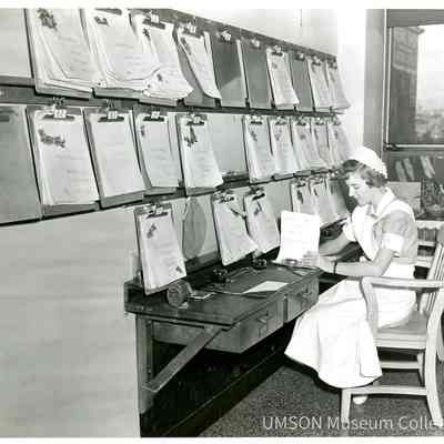 Student nurse updating charts at University Hospital