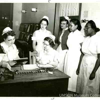 Senior nursing students handing out assignments