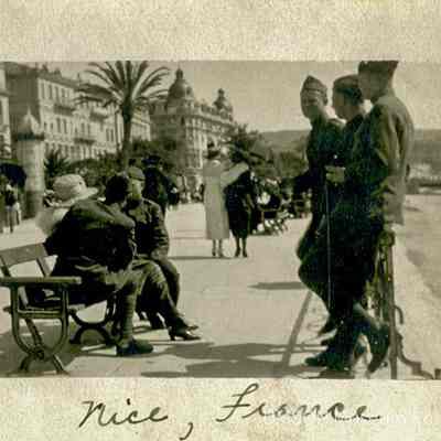Nice, France. Soldiers in uniform on the esplanade, hotels and palm trees in the background, 1919