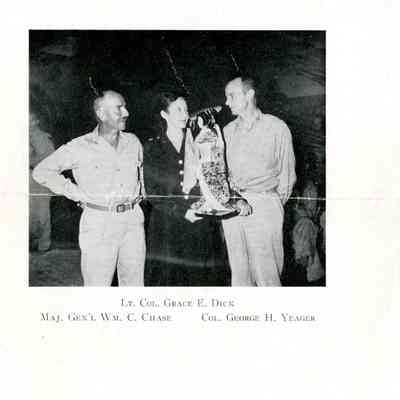Halftone image of Lieutenant Colonel Grace E. Dick, Major General William C. Chase, and Colonel George H. Yeager with Japanese doll, 1945