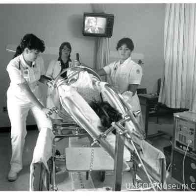 Nursing students turn a patient in a Stryker frame as a nurse supervisor watches, University of Maryland Medical Center