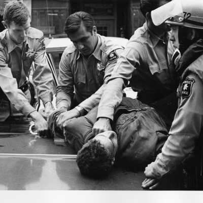Police handcuffing rioter on Telegraph Avenue