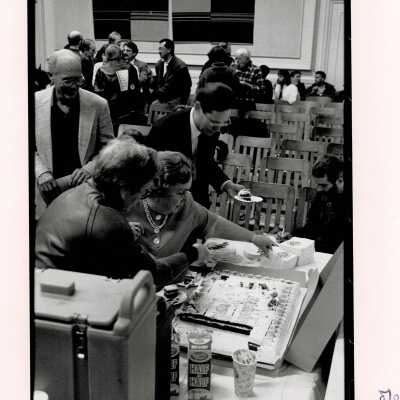 Shirley Dean cutting a congratulatory cake.