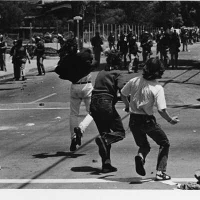 Students throwing rocks at police on Telegraph Avenue
