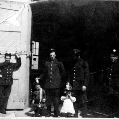 Firemen at firehouse with children