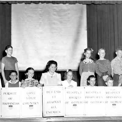 Students at Thousand Oaks present on the auditorium stage