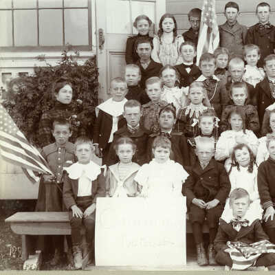 Class with "Columbus School" sign