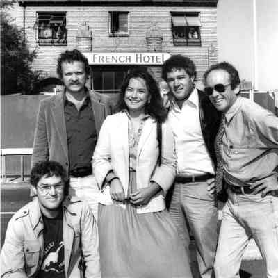 A group portrait in front of The French Hotel