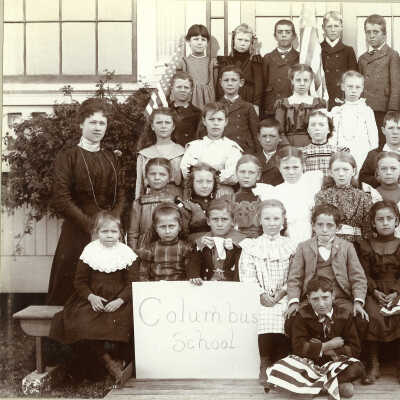 Class with "Columbus School" sign