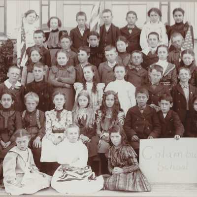 Class with "Columbus School" sign