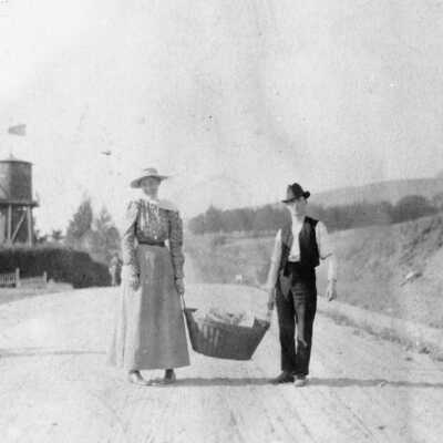 Spruce St. Man & woman carrying basket, 1300 block, Spruce Street