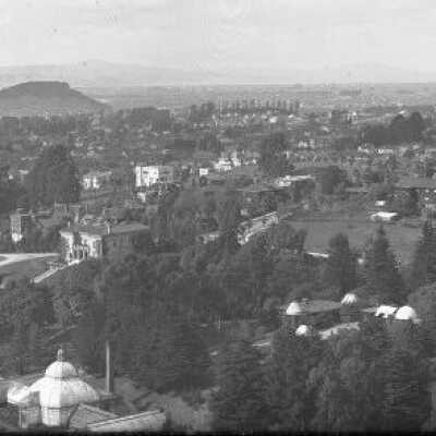 View northeast of University of California conservatory, president's house, with Albany Hill in distance