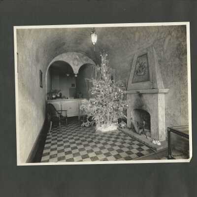 12: Unidentified interior; Christmas tree in front of fireplace. 