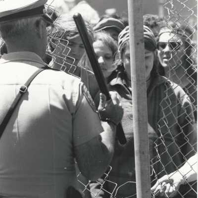 Cut down this fence; policeman with club