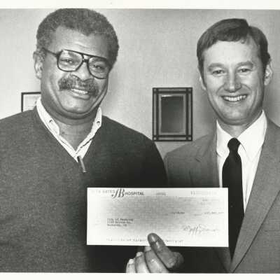 Photograph by Debra Jensen. Accepting check from Ken W. Sargent, Pres., Alta Bates Corp. n.d.: 2011.060.336j