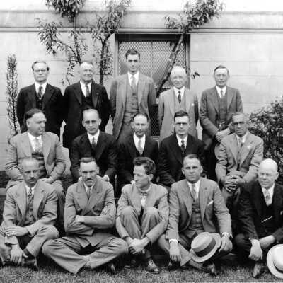 Group of men in front of large building