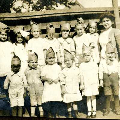 School children wearing paper caps.