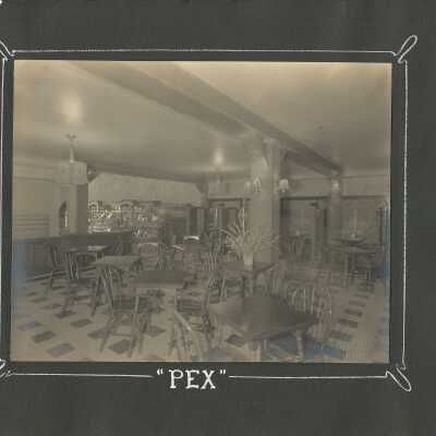 8: “Pex.” interior with tables and chairs. 