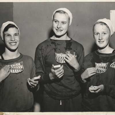 Three women swimmers with AAU sweatshirts