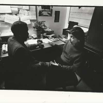 2011.060.160 c: Mark Koehler, photog. 12/1/1988. Advises street panhandler about getting DMV ID card.