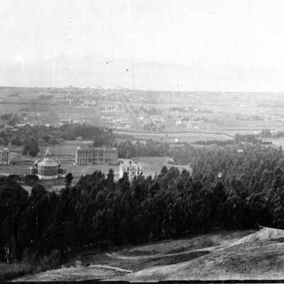 View west from hills to the bay; university campus with early buildings