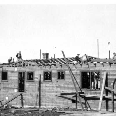 House under construction -- men on roof
