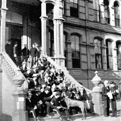 University of California North Hall with students in top hats on steps