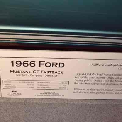 The image shows a museum display for a 1966 Ford Mustang GT Fastback with detailed specifications.