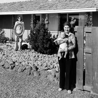 Lois (Adolf) Houle, in front, holds her grandson Kevin, while her daughter, Jody Sellers, holds a photograph of Lois's mother. Toppenish, Yakima Valley, Washington.