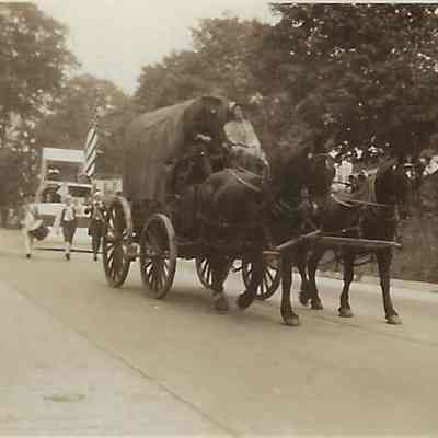 Ralph and Alice Sutton Sitting on a Covered Wagon