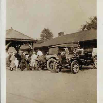 Cars and People Near the Railroad Depot