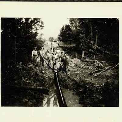 Workers next to pipeline