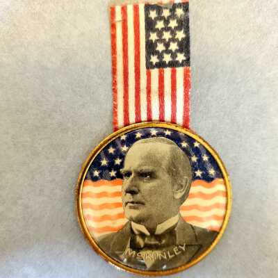 Black and White McKinley Image With Red, Blue, and White Flag Background Medal