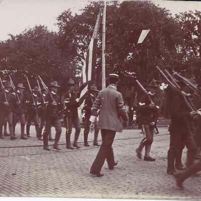 Soldiers Walking Passed an American Flag