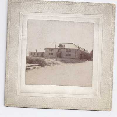 Building with modified Mansard roof and gabled dormers.