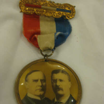 McKinley and Roosevelt pin for The Wholesale Dry Goods Republican Club