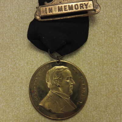 "In Memory" 3 part brass and cloth badge.