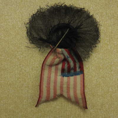 McKinley mourning pin with flag and black draping.