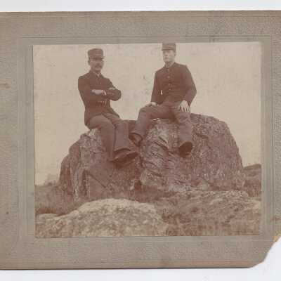 Two soldiers on a boulder.