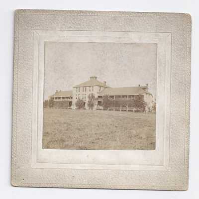 Unknown two story building with long porches.