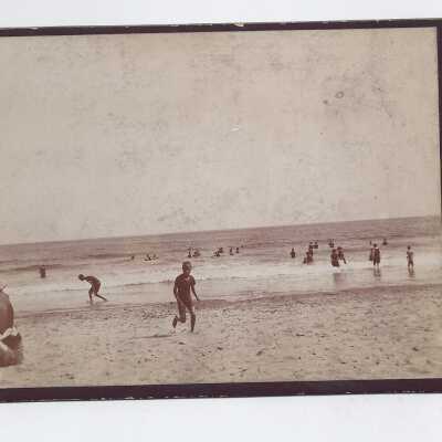 People cavorting on an unknown beach.