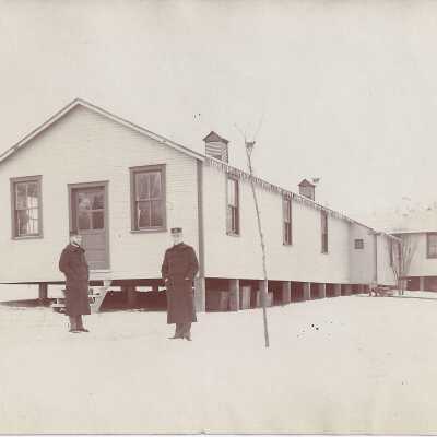 Soldiers Standing Outside of Barracks
